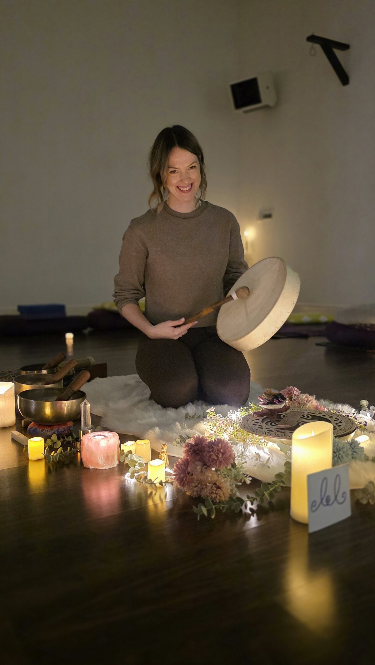 Orla setting the space — candles and flowers before a workshop session